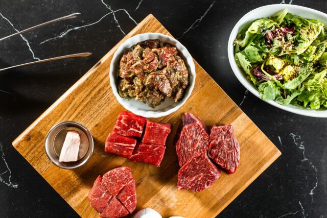 table view of korean bbq steak platter and salad