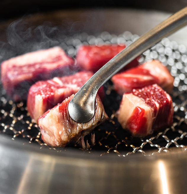 close up of steak being grilled korean bbq-style